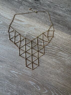Minimalist geometric bib necklace in gold tone metal with adjustable length